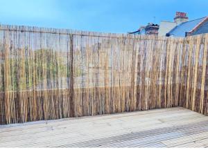 a wooden fence in front of a wooden deck at Studio Apartments Central London in London