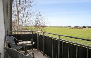 a balcony with a table and chairs and a field at Beautiful Apartment In Dalmose With Wi-fi 