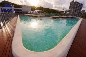 a large swimming pool on the roof of a building at Setai Yacht Premium - By Almare Flats in João Pessoa
