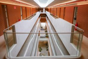 an empty corridor in a building with a glass floor at Setai Yacht Premium - By Almare Flats in João Pessoa