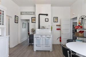 a kitchen with a white stove and a table at Downtown Urban Flat - close to SMART Station in Santa Rosa