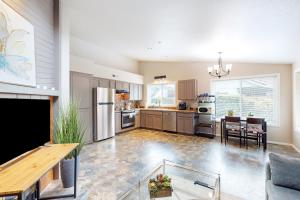 a large kitchen with a table and a dining room at The Peaceful Den in Eugene