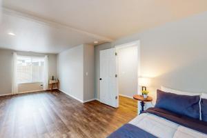 an empty bedroom with a bed and a window at The Peaceful Den in Eugene