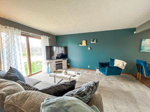 a living room with a couch and a tv at New 3 bd 2 bath Hot tub in Omaha