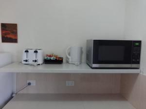 a microwave sitting on top of a kitchen counter at Forster and Wallis Lake Motel in Forster