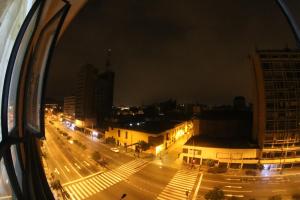 a view of a city at night from a window at El Lugar más Centrico de Lima in Lima