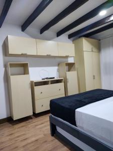 a bedroom with white cabinets and a bed at Casa La Riviera in Santa Rosa de Cabal