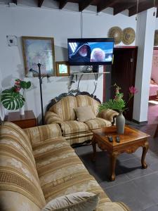 a living room with two couches and a tv at Apartamentos Rosarito.!! Con Vista al Mar ! in Rosarito