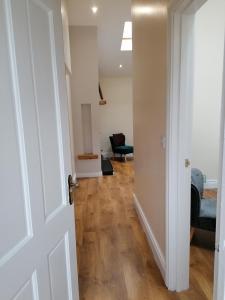 an open door to a living room with a chair at The Beeches in Newry