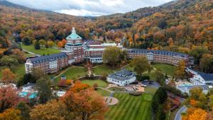 an aerial view of a building in the middle of a forest at The Omni Homestead Resort in Hot Springs
