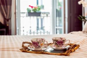 2 tasses de thé et un plateau sur une table dans l'établissement La Maison Gobert Paris Hotel Particulier, à Paris