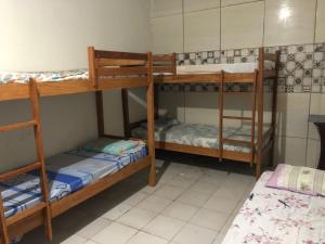 a room with three bunk beds in a room at Lê'Frevo Pernambucano Hostel in Recife