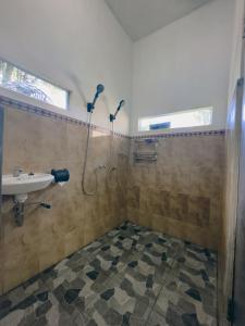 a bathroom with a shower and a sink at Homestay Sente in Munduk