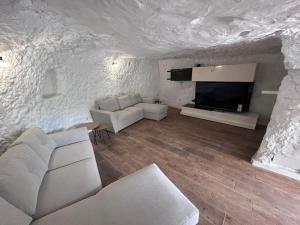 Et opholdsområde på Casa cueva las rosadas & piscina