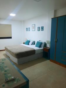 a bedroom with a bed and a blue cabinet at Las Arecas - 3° B in Puerto Iguazú