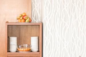a wooden shelf with a bowl of fruit on it at Palm Beach Plaza Hotel in Montevideo