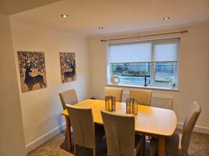 a dining room with a table and chairs and a window at 3 Severn close Contractor home in Oakham in Oakham