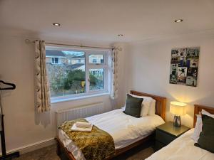 a bedroom with two beds and a window at 3 Severn close Contractor home in Oakham in Oakham
