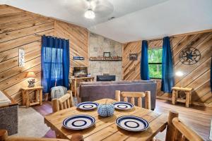 a dining room with a table and a couch at Couples Getaway Hot Tub & Mountain View in Sevierville