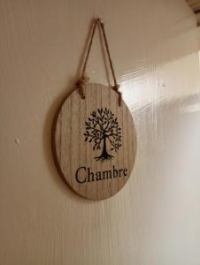 a wooden sign with a tree on it hanging on a wall at Salthill Stay B&B in Galway