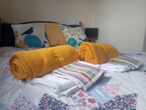 stos koców i ręczników na łóżku w obiekcie Salthill Stay B&B w Galway