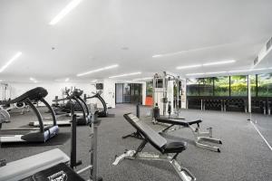 a gym with several treadmills and cardio machines at Center 1-Bed with Gym, BBQ and Stunning Views in Canberra