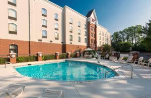 a swimming pool in front of a building at Hampton Inn Belmont at Montcross in Belmont