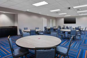 a conference room with tables and chairs and a screen at Hampton Inn Charlotte Uptown in Charlotte +39 photos