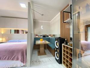 a bedroom with a bed and a desk in it at Loft classe A in Santa Cruz do Sul
