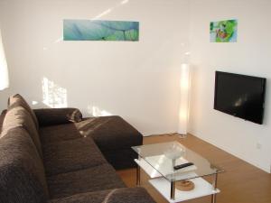 a living room with a couch and a tv at Stars Berlin Apartments in Berlin