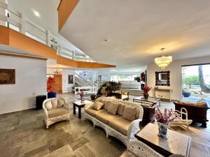 a large living room with couches and tables at Luna Hotel Boutique - Beira Mar in Guarujá
