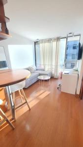 a living room with a table and a couch at Apartmento en providencia in Santiago