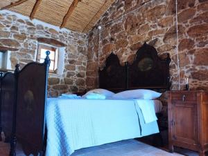 Postel nebo postele na pokoji v ubytování holiday home su Niberalzu