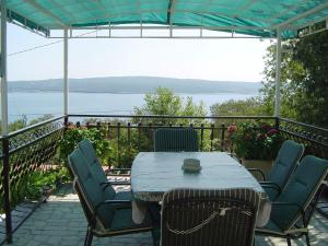 a table and chairs on a balcony with a view of the water at Apartment Ane in Dramalj