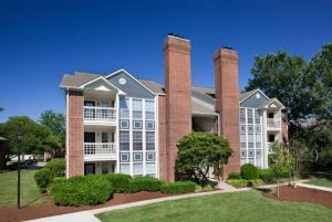 a large apartment building with two tall brick chimneys at Modern Luxe 2bd2ba I Free Parking I Wyndham in Hampton