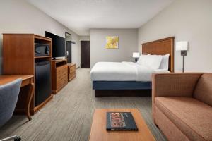 a hotel room with a bed and a couch at Hampton Inn Memphis-Walnut Grove/Baptist East in Memphis