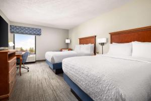 a hotel room with two beds and a desk at Hampton Inn Memphis-Walnut Grove/Baptist East in Memphis