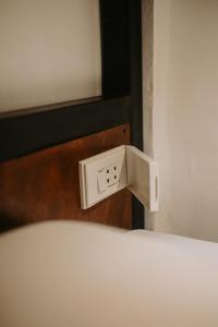 a white electrical outlet on the side of a bed at Everyday Sunday Formerly Carl's Island Inn in Bantayan Island