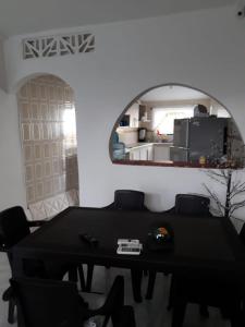 a dining room with a table and a mirror at casa vacacional cabañas altamar san andres islas in San Andrés