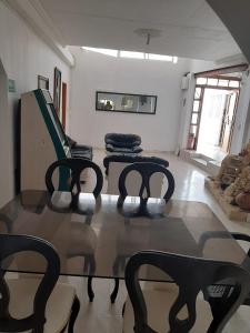 a living room with three chairs and a table at casa vacacional cabañas altamar san andres islas in San Andrés