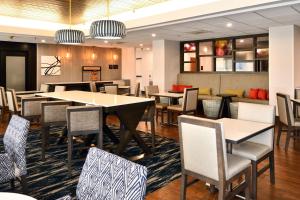 a dining room with tables and chairs in a restaurant at Hampton Inn Santee-I-95 in Santee
