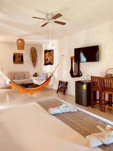 a living room with a hammock and a couch at Hotel Para Ti - Adults Only in Holbox Island