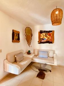 a living room with a couch and a table at Hotel Para Ti - Adults Only in Holbox Island