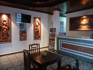 a dining room with a table and a fireplace at Andy's Place in Siem Reap