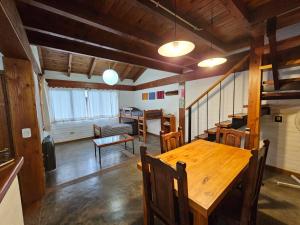 a dining room with a wooden table and chairs at Punto Sur Cabañas in El Bolsón +32 photos