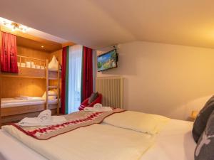 a bedroom with a bed with towels on it at Winter Chalet Kaprun in Kaprun