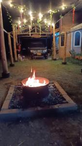 a fire pit in a yard at night at Casa de Campo EL LAGUITO - Mesa de los Santos in Los Santos