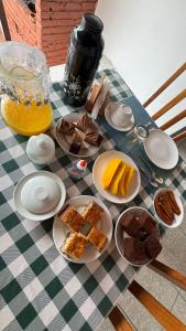 a table with plates of food on a checkered table at Pousada da Rita in Lençóis