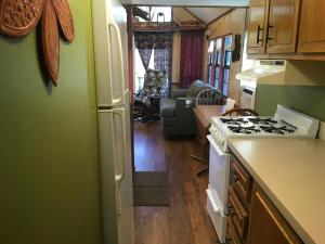 a kitchen with a refrigerator and a stove top oven at Cascades Inn - Cabin #2 - Full Kitchen in Tiger