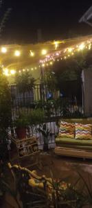 a patio at night with lights and a bench at La Ruta del Jazz in Santa Cruz